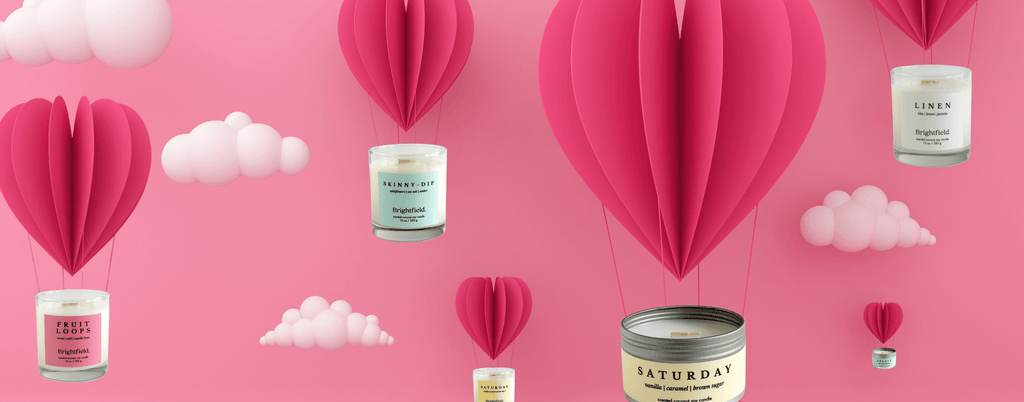 Valentine's Day candles floating on heart hot air balloons in front of a pink background, Valentine's day gifts, Valentine's Day candles